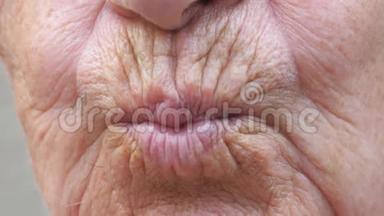 闭上<strong>老奶奶</strong>的嘴，把空气吻进相机里。 一位皮肤皱巴巴的老女人做接吻动作